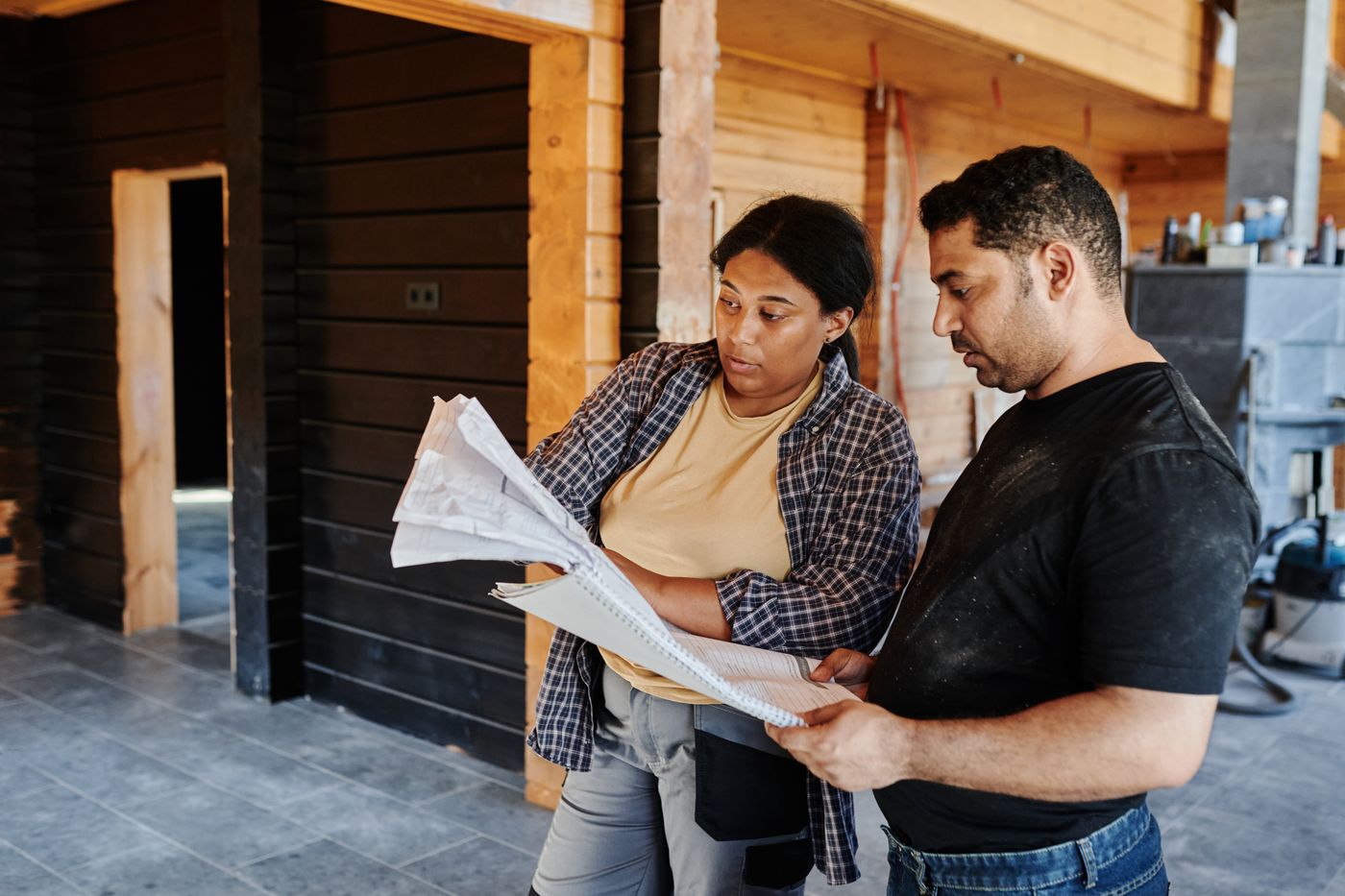Illustrative stock photograph of two people discussing plans at a worksite